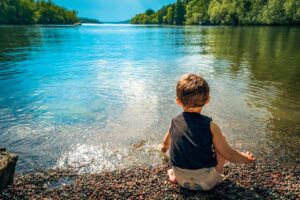 Jeune enfant au bord d'un lac
